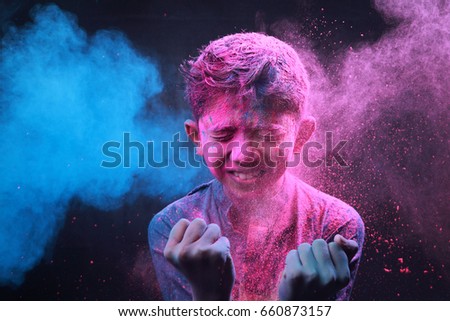 Little boy plays with colors.Concept for Indian festival Holi.