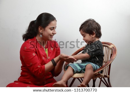 Little boy plays with his mother