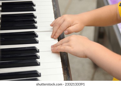 A little boy plays the piano. Music lessons for children, the child learns a musical instrument - Powered by Shutterstock