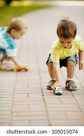 Little Boy Plays With Toy Car