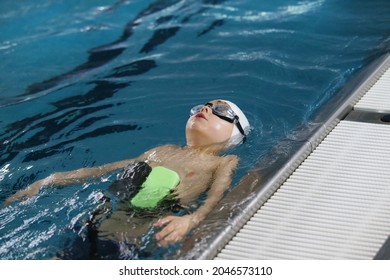 little boy in the pool learning to 
swim on the back - Powered by Shutterstock