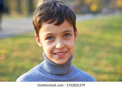 Little Boy Portrait With Big Smile Outside.