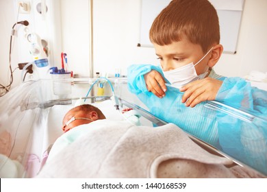 Little Boy With Premature Infant Brother, Hospital