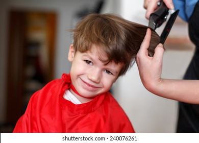 Little boy at professional barber, hair saloon
