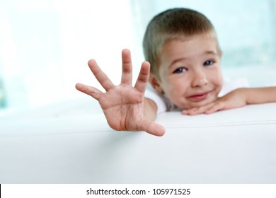 Little Boy Reaching Out Towards The Camera