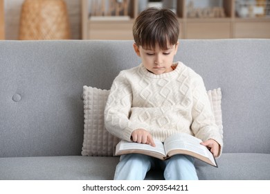 Little Boy Reading Bible At Home