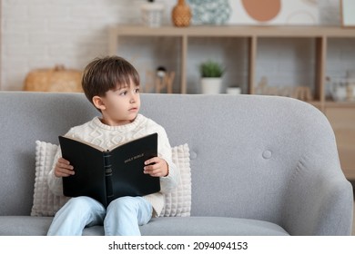 Little Boy Reading Bible At Home