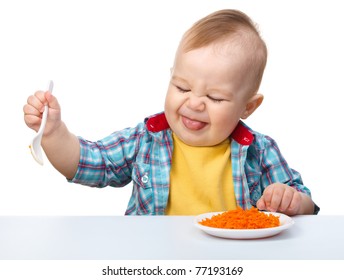 Little boy refuses to eat making unpleasant grimace, isolated over white