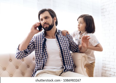Little boy requires attention from busy father. Lack of parental attention.