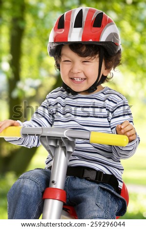 A funny boy riding his bicycle