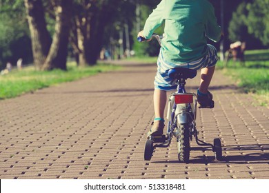 Little Boy Riding Bike Outdoors