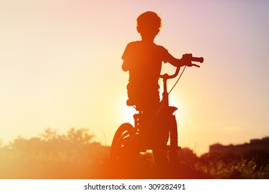 little boy riding bike at sunset, active kids sport - Shutterstock ID 309282491