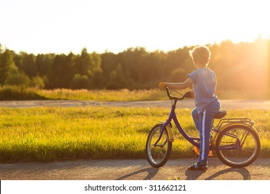 little boy riding bike at sunset, kids sport and  active lifestyle
