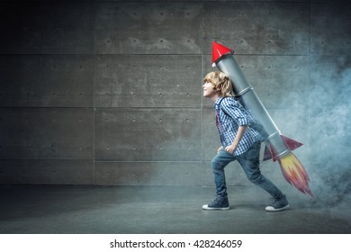 Little Boy With Rocket In Studio