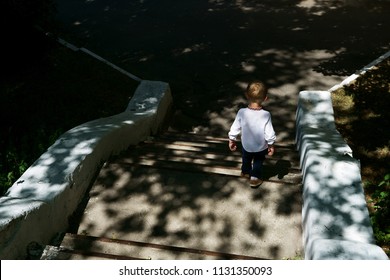 Little Boy Running Down The Stairs                               