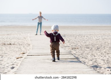 Little Boy Running To His Mom On The Beach.