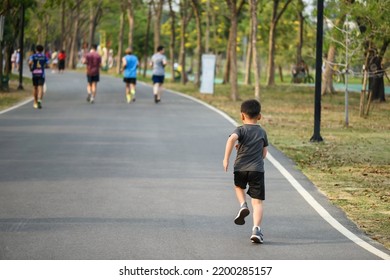 Little boy running or jogging on park running track in park. Bodybuilding, kid sport, and healthy lifestyle concept. Back view. - Shutterstock ID 2200285157