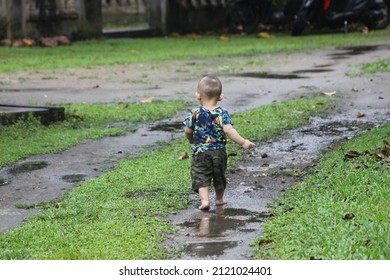 Little Boy Running Outside The Yard