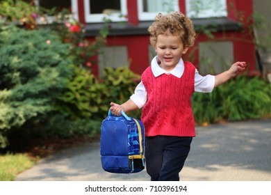 A Little Boy Running To School With His Back Pack