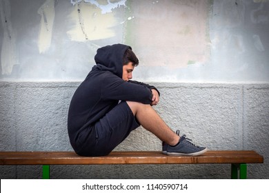 Little Boy Sad Sitting Alone At School Hides His Face