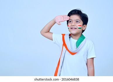 Little boy saluting wearing white kurta pajamas on the occasion of Indian Independence day celebration