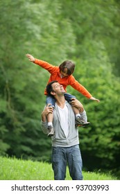 Little boy sat on father's shoulders