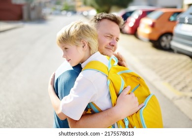 Little Boy Says Goodbye And Hugging To His Father Before Going To School. Dad Brought His Son By Car. Quality Education For Children. Child Is A First Day Of School. Kids Fear.