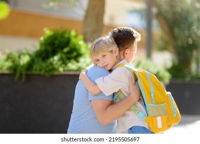 Little Boy Says Goodbye And Hugging To His Father Before Going To School. Dad Brought His Son By Car. Quality Education For Children. Child Is A First Day Of School. Kids Fear.