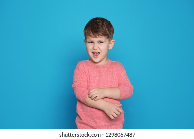 Little Boy Scratching Arm On Color Background. Annoying Itch