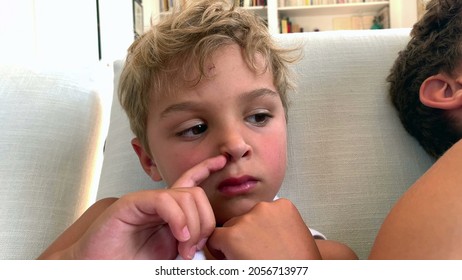 Little Boy Scratching Nose With Finger