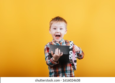 Little Boy In Shirt Holding Black And White Present For Girl Or Mother, Valentines Day, Mother's Day, Happy Surpeised And Cute Child Higging His Gift.