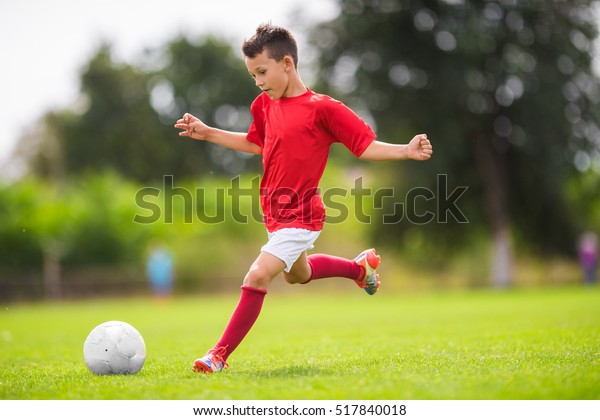 Little Boy Shooting at\
Goal