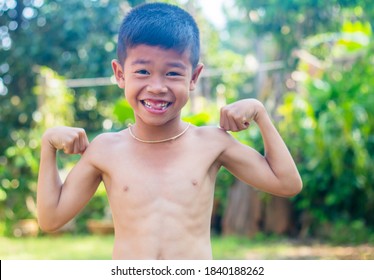 Little Boy Showing His Muscles 