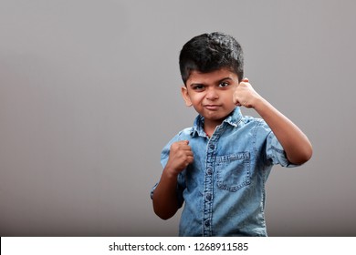 Little boy shows fighting gestures