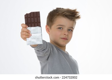 little boy shows his favorite chocolate bar