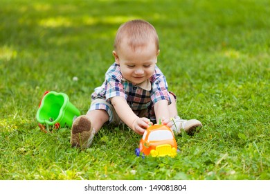 Little Boy Sits On Grass Plays Stock Photo 149081804 | Shutterstock