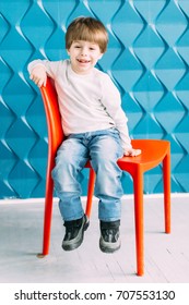 Little Boy Sitting On A Chair