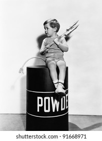 Little boy sitting on powder keg