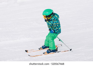 Little Boy Skiing On Mountain 