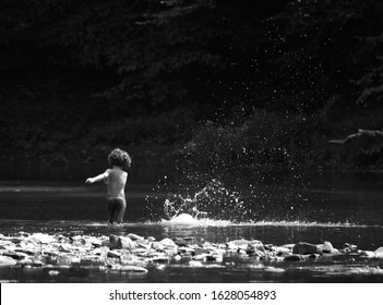 Little Boy Skipping Rocks On The River