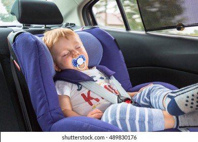 Little Boy Is Sleeping In The Car Safety Seat