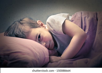 little boy sleeping in his bed - Shutterstock ID 150088664