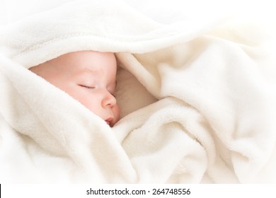 Little Boy Sleeping On Soft White Blanket