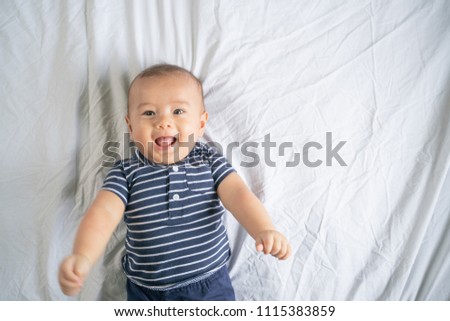 Similar – Der kleine Junge lächelt im Bett in seinem eigenen Zimmer.