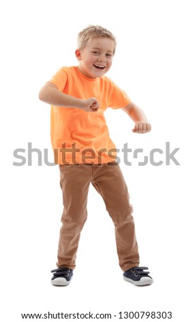 LITTLE BOY SMILING HAPPY WHILE MOVING AND MAKING FUN ISOLATED ON WHITE BACKGROUND