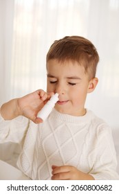 Little Boy Spraying Medicine In Nose, Nose Drops. Toddler Child Using Nasal Spray. Runny Nose, Cold, Flu, Illness, Virus. Close Up.