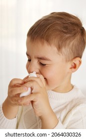 Little Boy Spraying Medicine In Nose, Nose Drops. Toddler Child Using Nasal Spray. Runny Nose, Cold, Flu, Illness, Virus. Close Up.