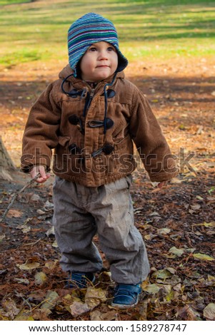 Similar – Image, Stock Photo Cute baby seeing falling leaves