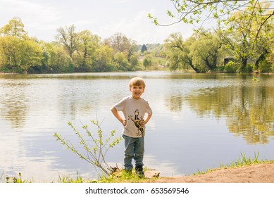 Little Boy Standing Near The Pond Summer