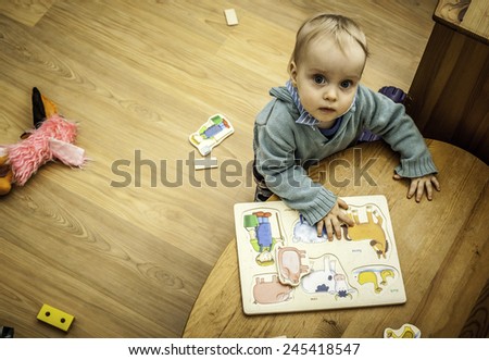 Similar – Baby girl playing with hair clips sitting in the floor